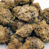 Wedding Cake, also known as Pink Cookies, is an indica-dominant hybrid resulting from crossing Triangle Kush with Animal Mints. It's celebrated for its incredibly sweet aroma and fruity flavor, resembling a blend of cookie sweetness and cherry pie fruitiness. This strain serves as a calming agent and appetite stimulator, beneficial for patients dealing with depression, fibromyalgia, MS, and similar conditions. While it can have sedative effects, it's known for calming nerves and alleviating anxiety without significantly impacting focus and energy. Common side effects include dry eyes and mouth. Wedding Cake is typically grown indoors and features a THC content of 25-27%. It boasts a dense, pine tree-like appearance, frosty with dark green leaves and adorned with thick orange hair, known for its sugary taste and high potency.